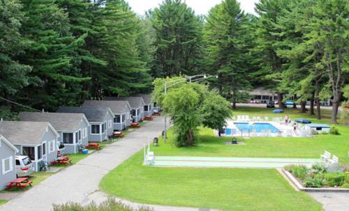 a row of cottages in a park with a pool at Elmwood Motor Court in Old Orchard Beach