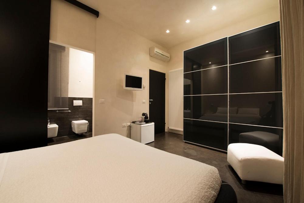 a bedroom with a white bed and a bathroom at B&B Lounge in Porto SantʼElpidio