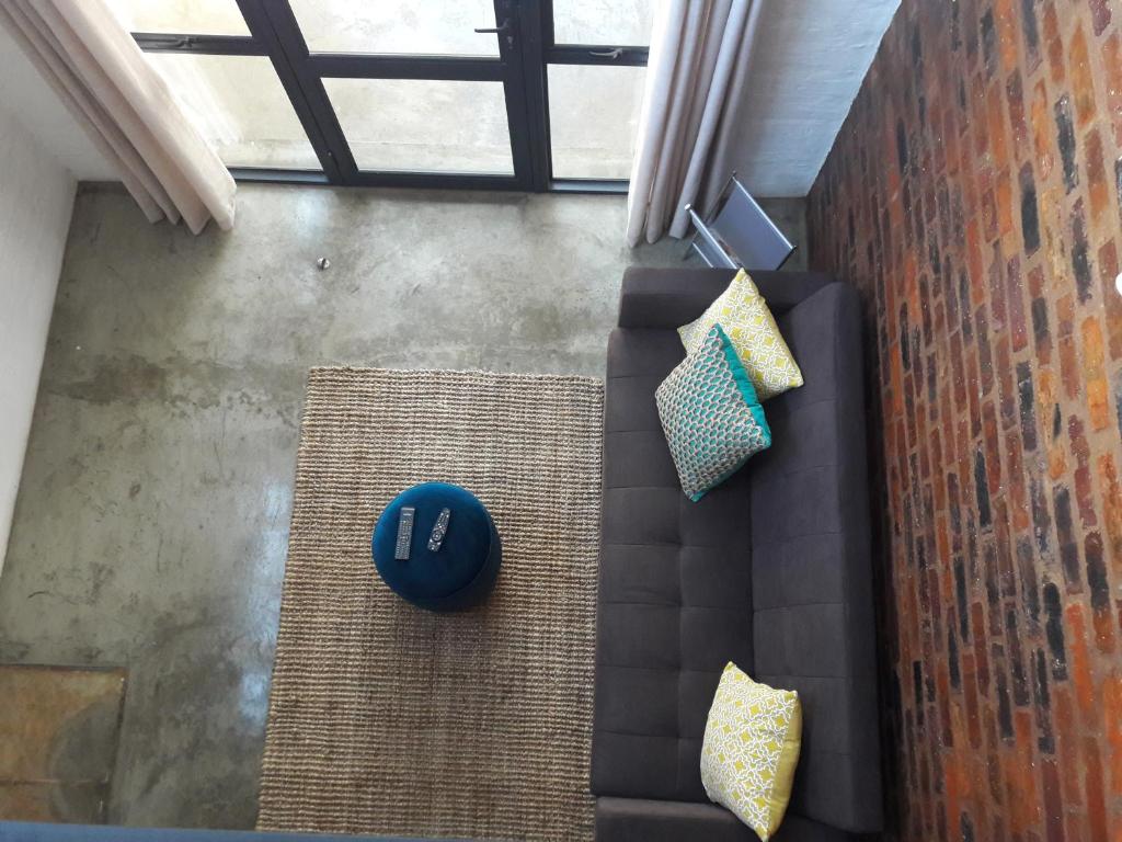 an overhead view of a living room with a couch and pillows at Entire Industrial-Style Loft in Maboneng in Johannesburg