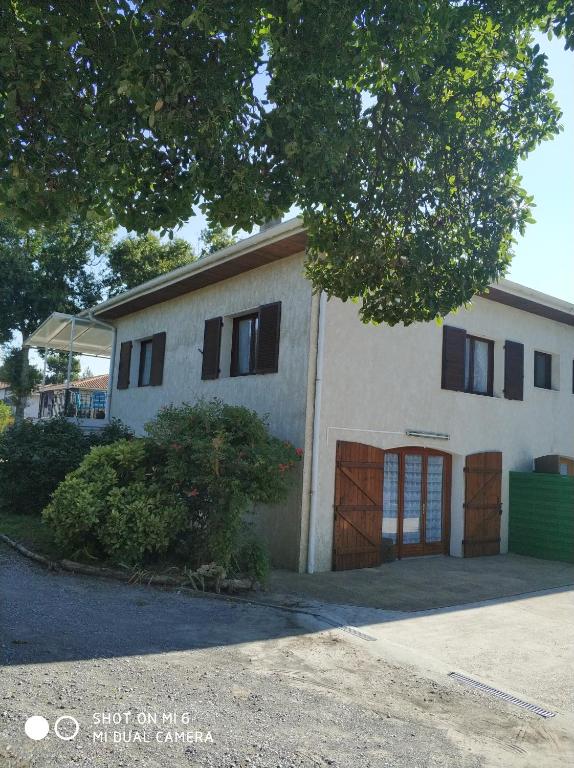 a large white building with black windows on it at Les Bananiers in Capbreton