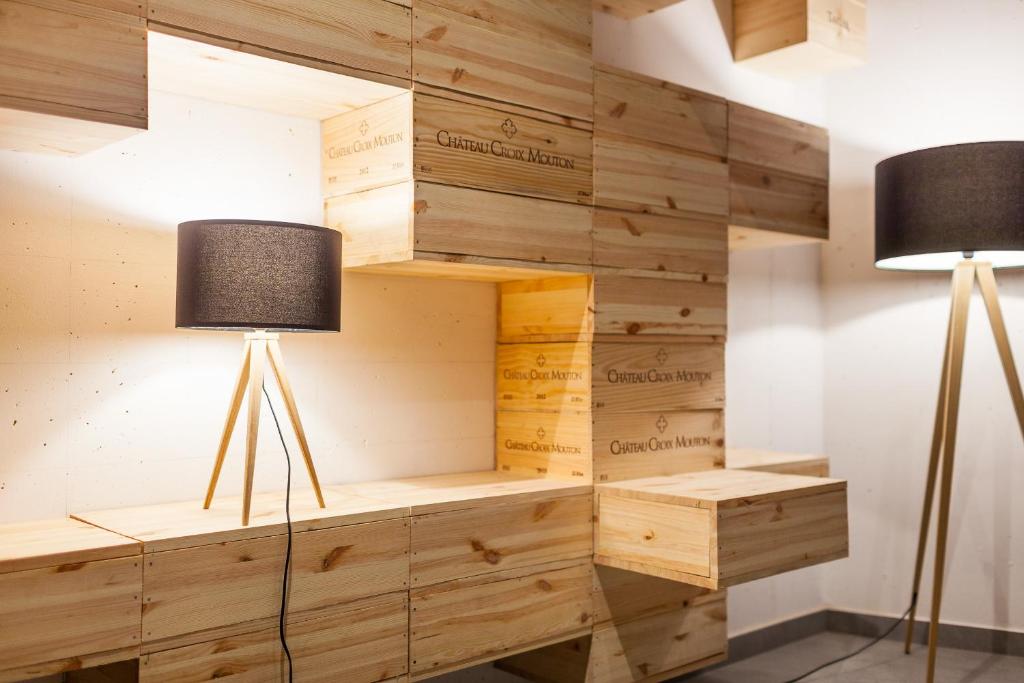 two lamps in a room with wooden walls at Hotel Ostrov in Tisá