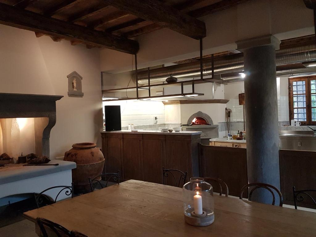 a kitchen with a table with a candle on it at Castello di Pratelli in Incisa in Valdarno