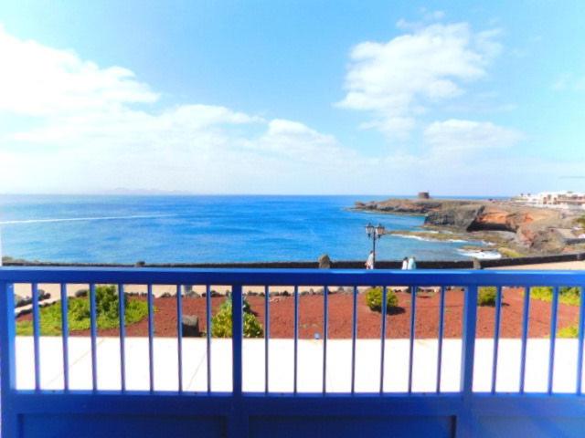 a view of the ocean from a balcony at Las Moreras Playa Blanca in Playa Blanca