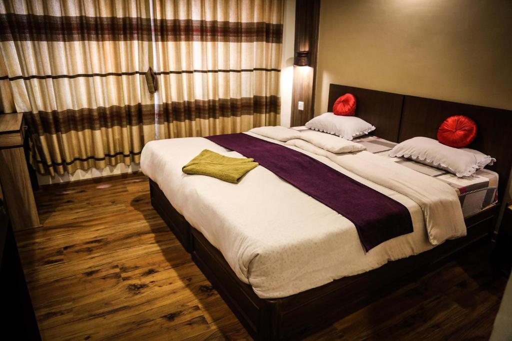 Postel nebo postele na pokoji v ubytování Kumari Guest House