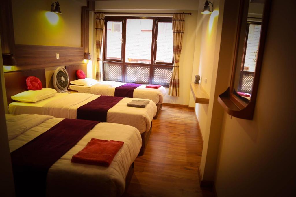 Postel nebo postele na pokoji v ubytování Kumari Guest House
