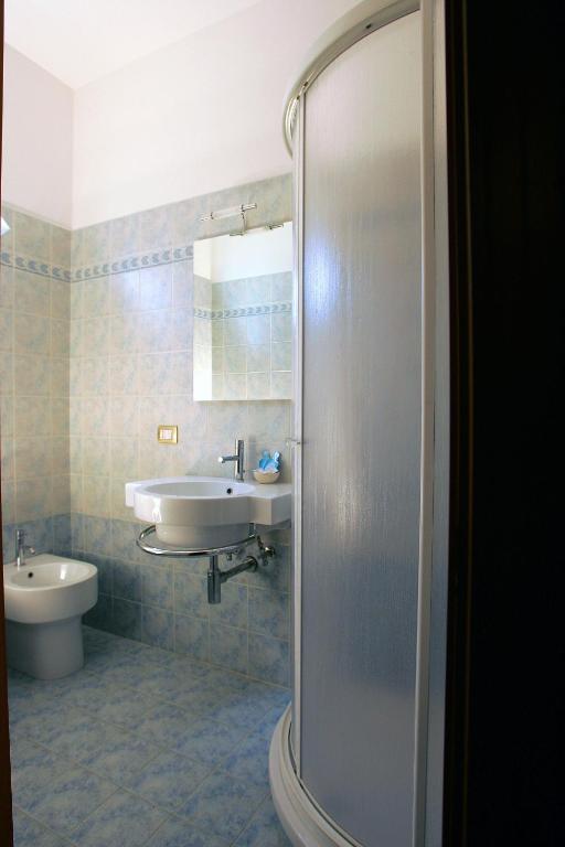 a bathroom with a sink and a toilet and a shower at Affittacamere Letizia Traballoni in Esanatoglia