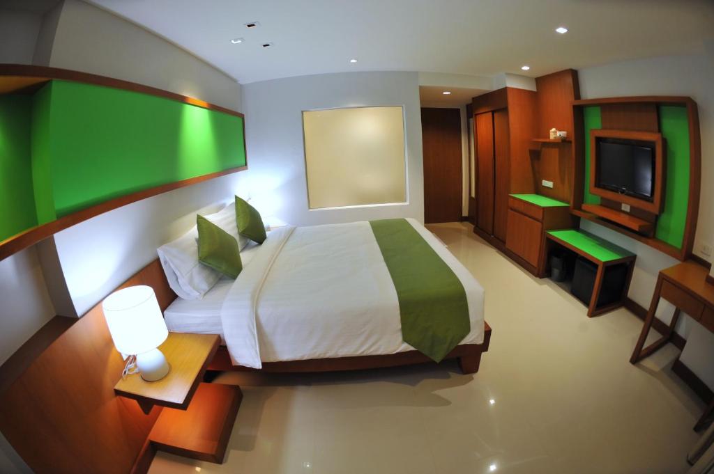 a bedroom with a bed and a flat screen tv at @Judy in Patong Beach