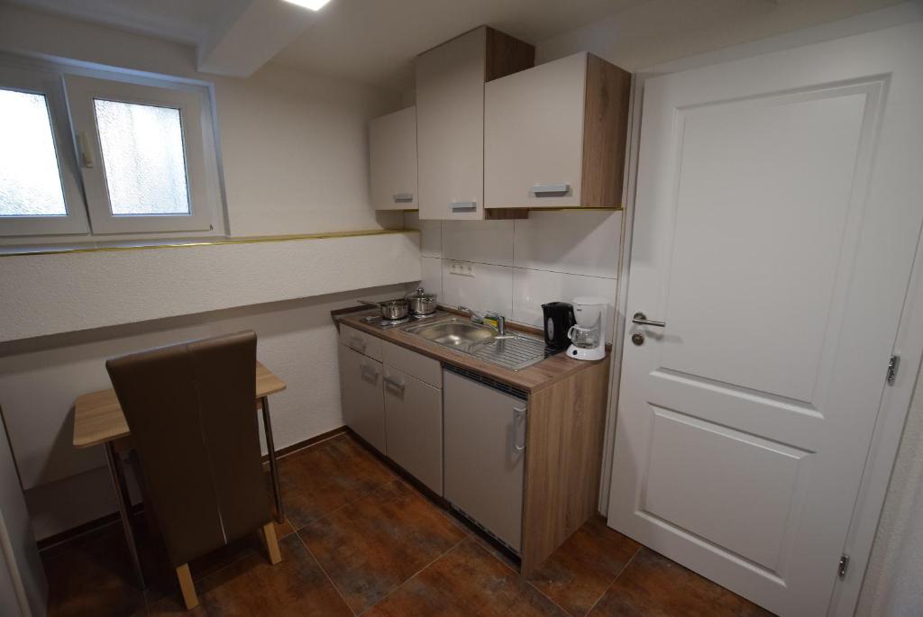 a small kitchen with a sink and a table at Apartment Terrotstraße in Stuttgart