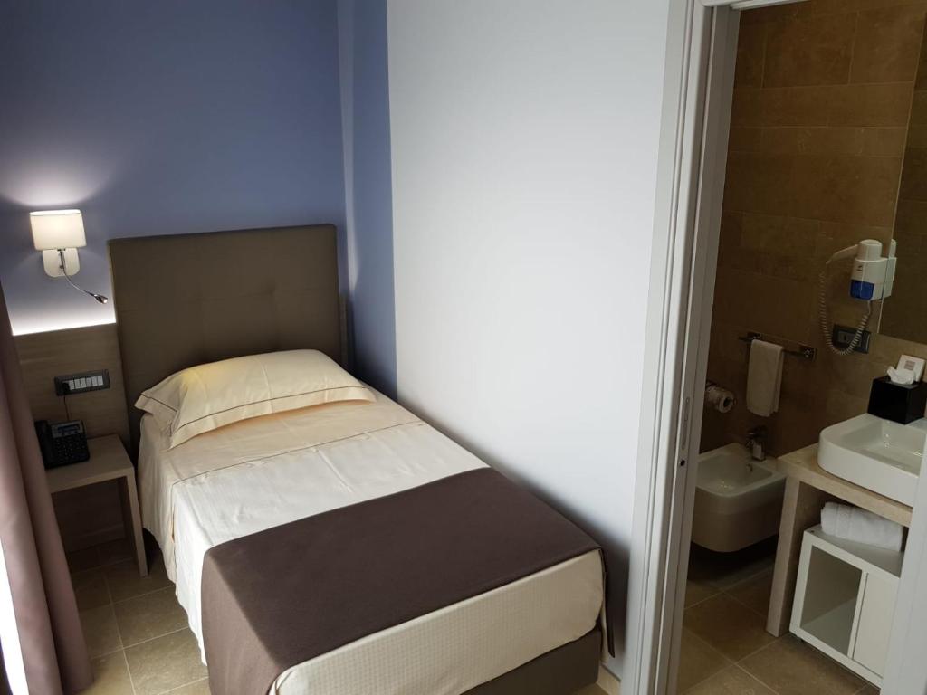 Postel nebo postele na pokoji v ubytování Netum Hotel