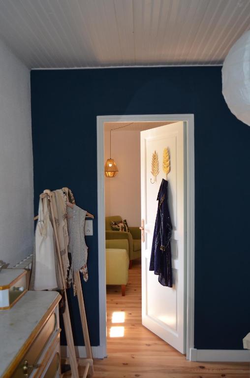 a room with a blue wall and an open door at Mas Mialou in Saint-Jean-du-Gard