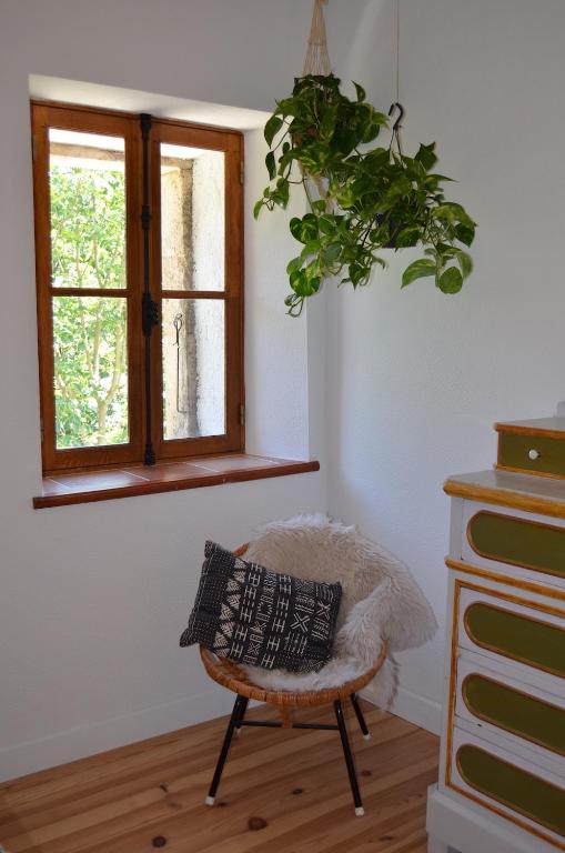 a room with a chair and a window at Mas Mialou in Saint-Jean-du-Gard