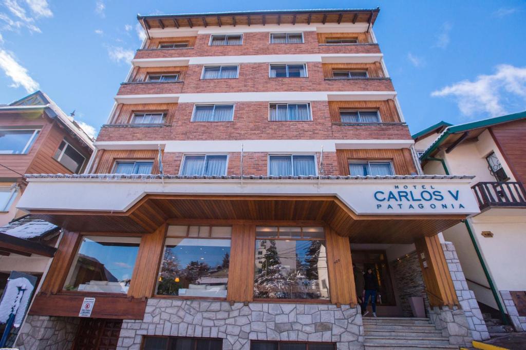 a tall building with a sign in front of it at Carlos V Patagonia in San Carlos de Bariloche