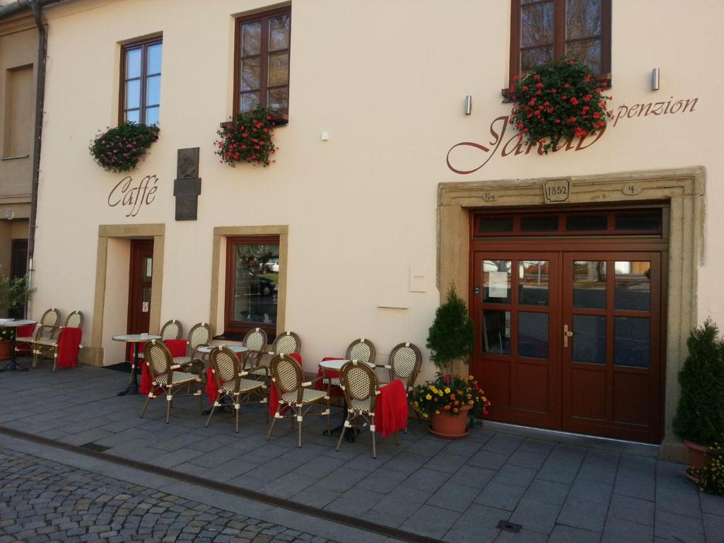 a restaurant with tables and chairs in front of a building at Penzion Jakub in Lanškroun