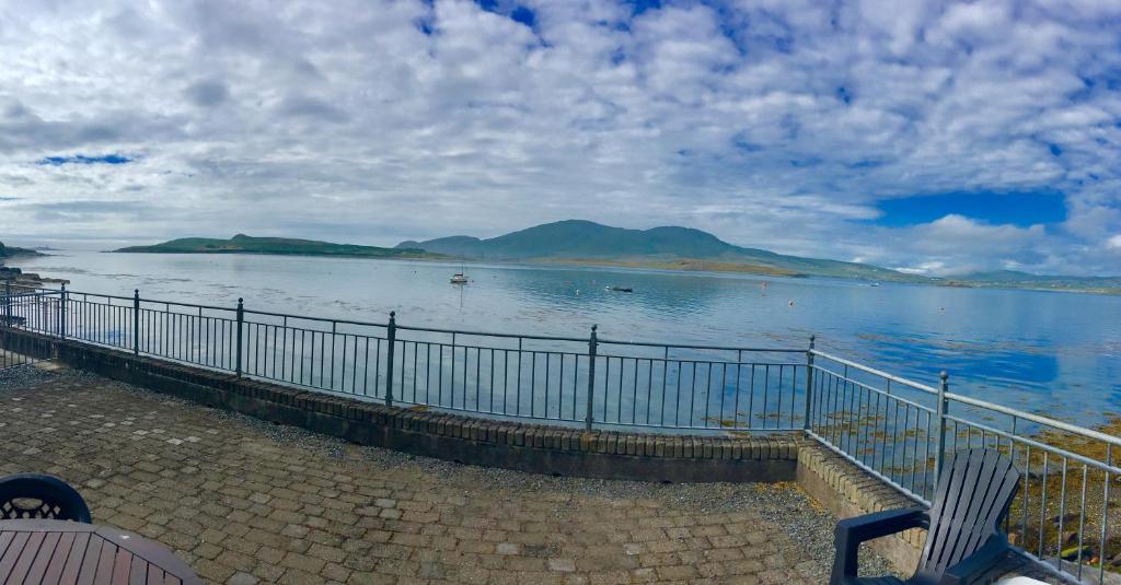 a view of a large body of water with a fence at Puffin Apartment in Valentia Island