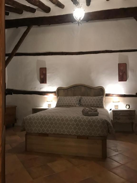a bedroom with a bed with two lights on the wall at El Portal de Moratalla in Moratalla