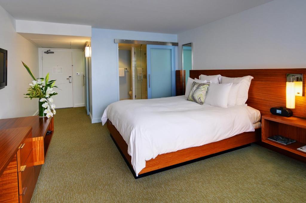a hotel room with a large bed and a television at Tower 23 Hotel in San Diego