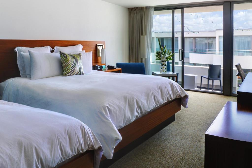 a hotel room with two beds and a balcony at Tower 23 Hotel in San Diego