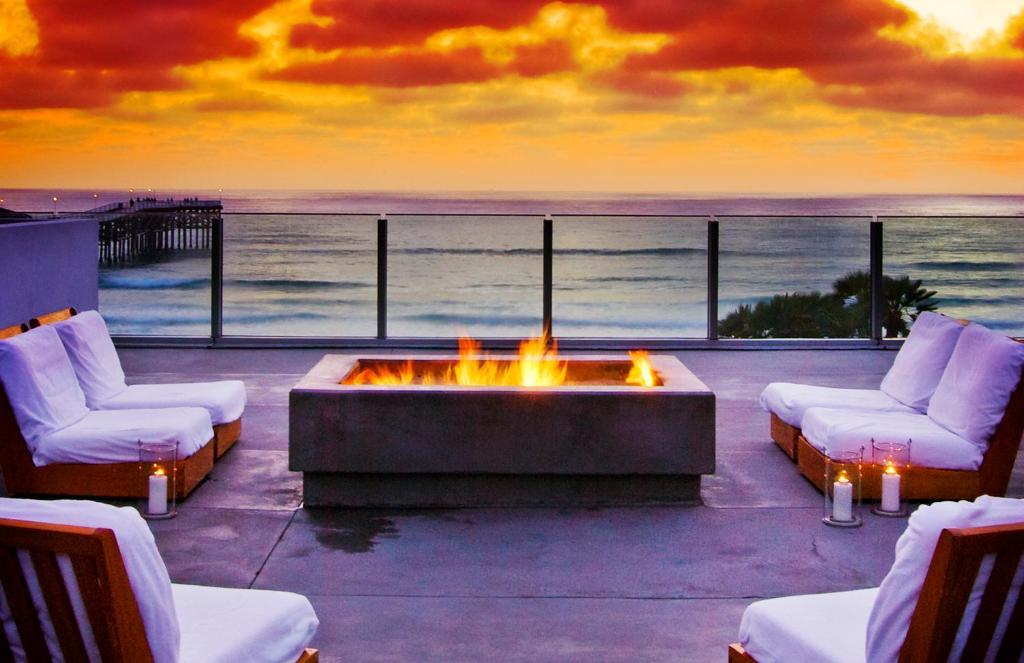 a fire pit on a patio with a view of the ocean at Tower 23 Hotel in San Diego