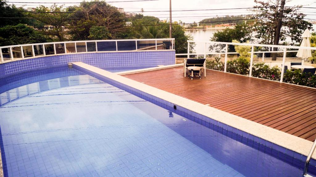 a chair sitting on the edge of a swimming pool at Privileg in Ilhéus