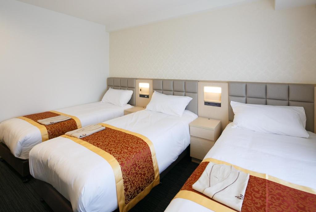 Postel nebo postele na pokoji v ubytování Day Nice Hotel Tokyo