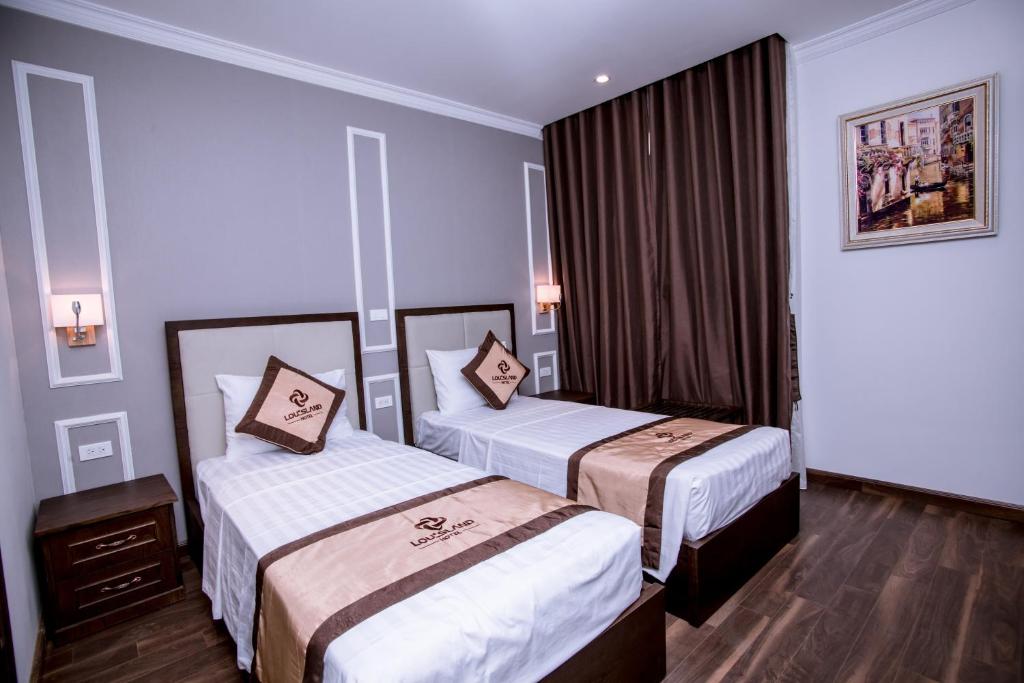 Postel nebo postele na pokoji v ubytování Louisland Hanoi Hotel