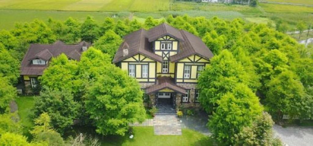 an aerial view of a large house with trees at Rothenburg Lodge in Wujie