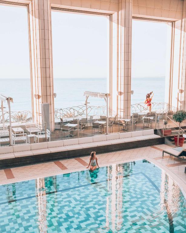 a woman in a swimming pool on a cruise ship at Hyatt Regency Nice Palais de la Méditerranée in Nice