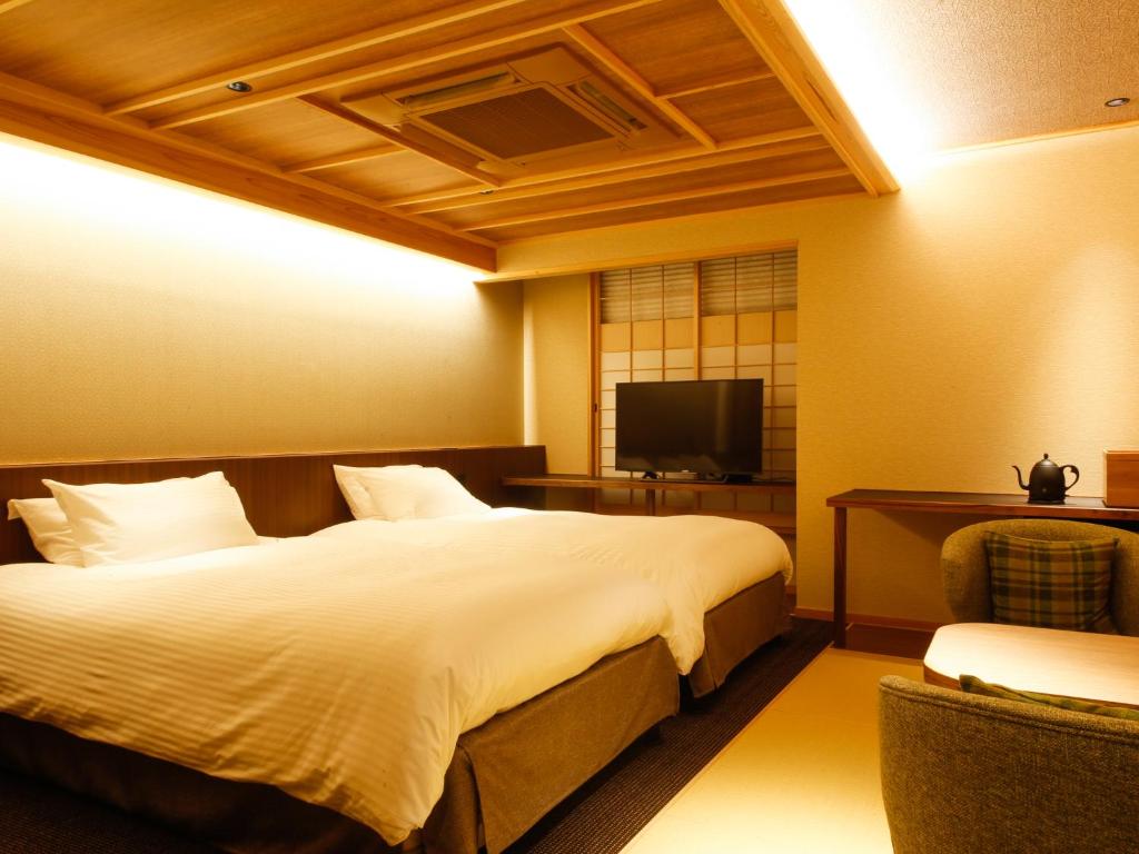 Postel nebo postele na pokoji v ubytování Minato Koyado Awajishima