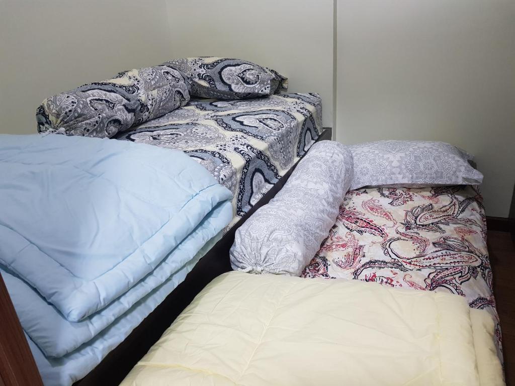 Кровать или кровати в номере KVA Syariah 2BR 1211