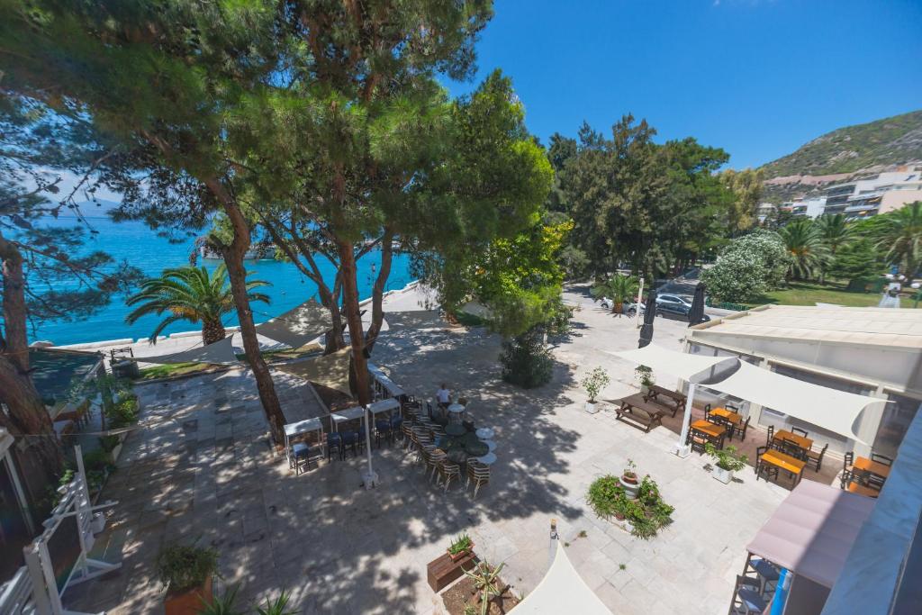 an overhead view of a patio with trees and the water at Hotel Akti in Loutraki