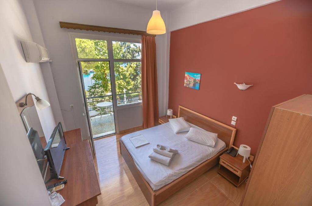 Postel nebo postele na pokoji v ubytování Hotel Akti
