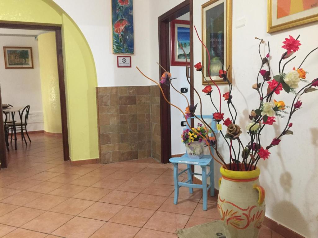 a hallway with two vases with flowers in it at Il Normanno B&B in Mileto