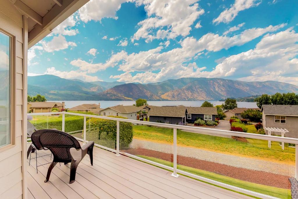 a porch with a chair and a view of the mountains at Wapato Point Lakeview in Manson