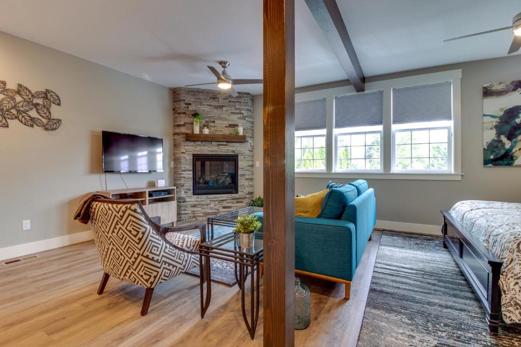 a living room with a blue couch and a fireplace at Johnson Street Studio in McMinnville