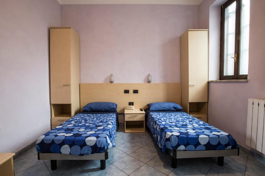 Postel nebo postele na pokoji v ubytování Albergo Ristorante Brera