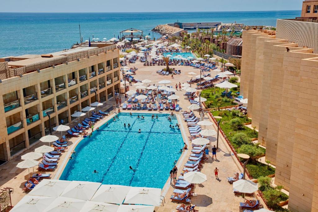 an overhead view of a swimming pool at a resort at Coral Beach Hotel And Resort Beirut in Beirut