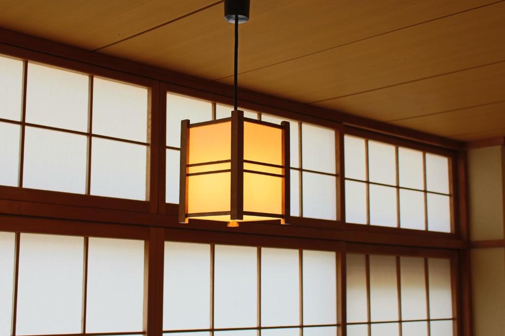 a chandelier hanging from a wall of windows at Miyajima Seaside Hotel in Miyajima