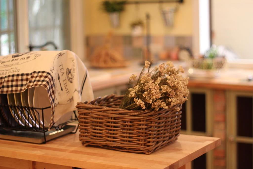 a basket of flowers sitting on a counter next to a appliance at Antique B&B in Hengchun South Gate