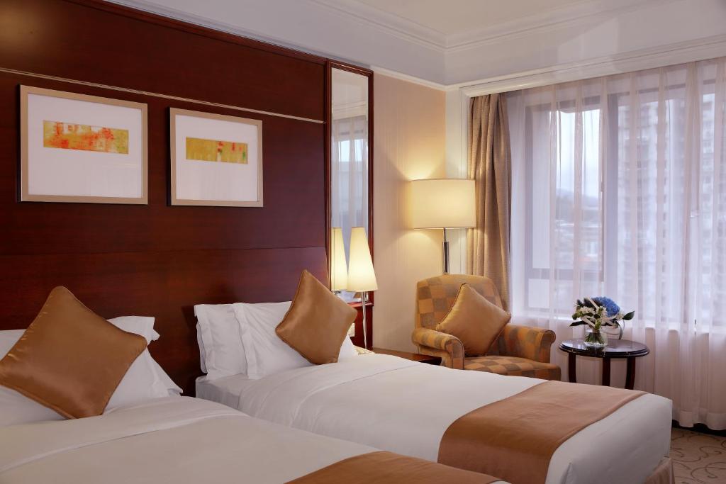 Postel nebo postele na pokoji v ubytování Hotel Royal Macau