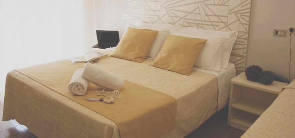 Postel nebo postele na pokoji v ubytování Hotel Sandra