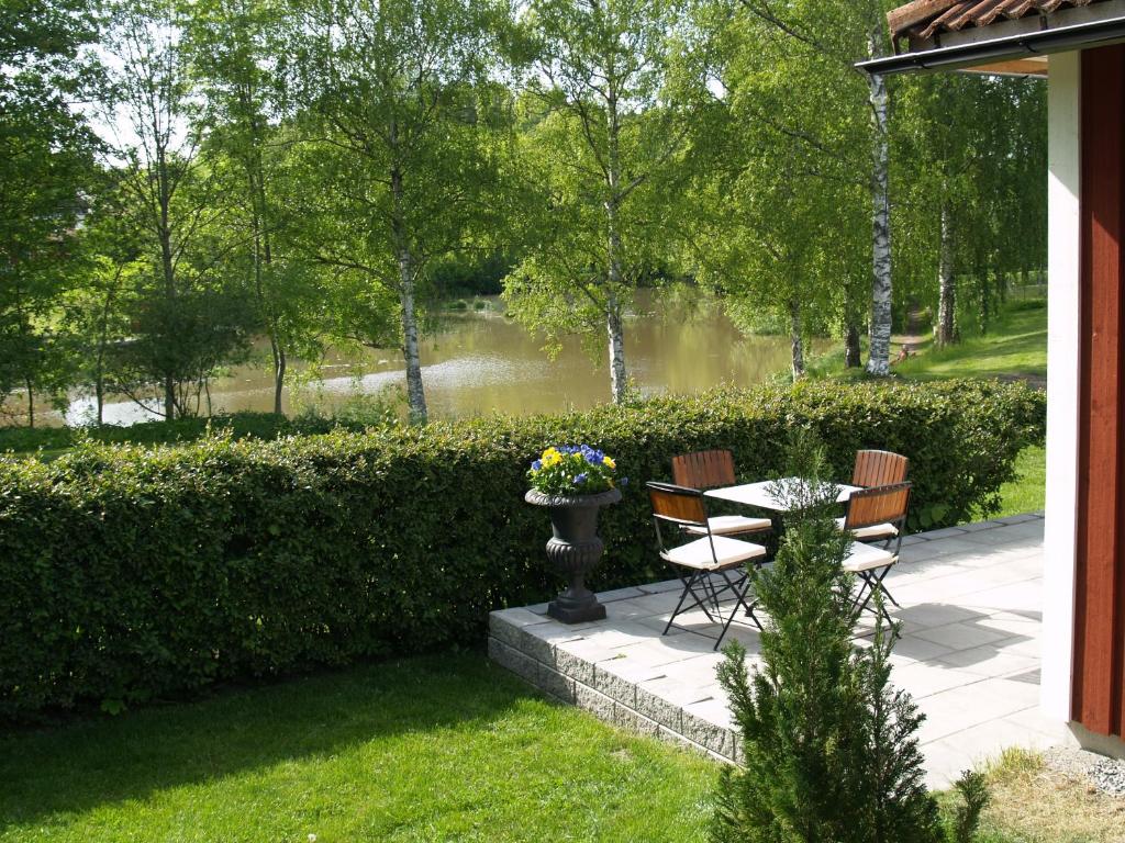 a patio with a table and chairs in a yard at Hotel Laurenti in Söderköping