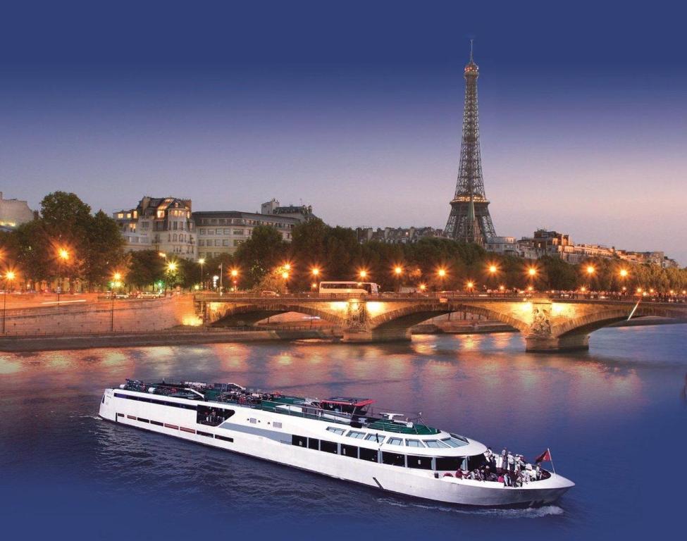 a boat on the river in front of the eiffel tower at VIP Paris Yacht Hôtel & Spa in Paris