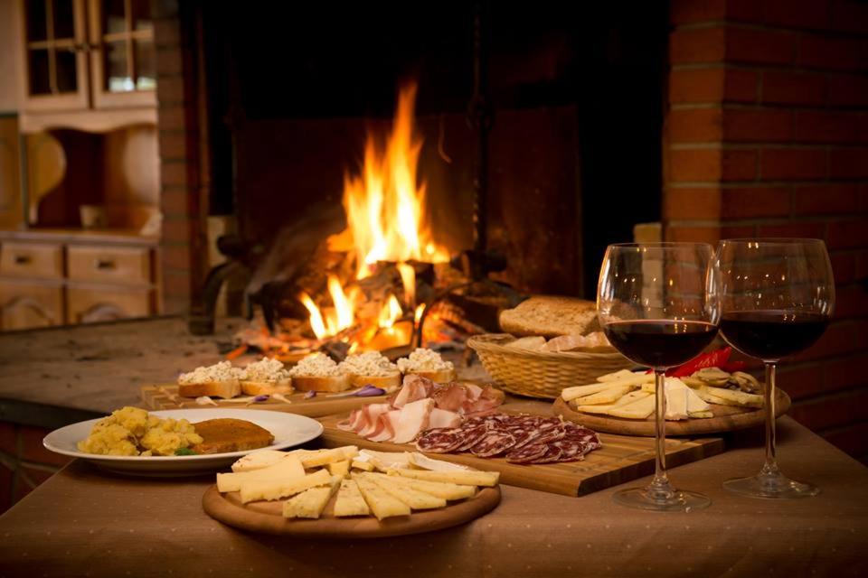 a table with plates of food and glasses of wine at Gostilna Lokve in Lokve
