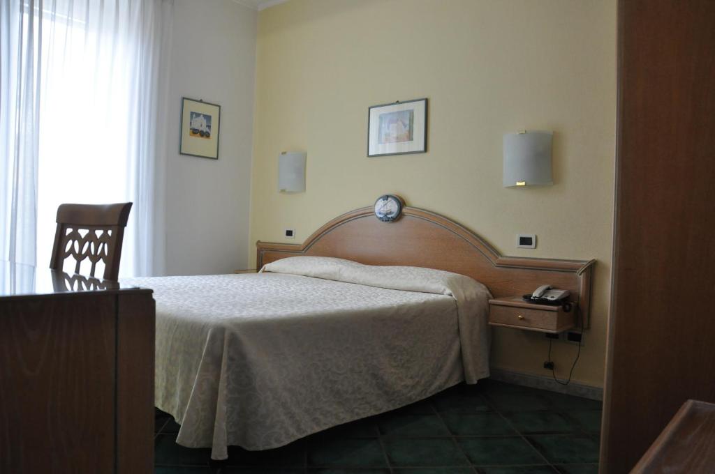 Postel nebo postele na pokoji v ubytování Hotel La Marticana
