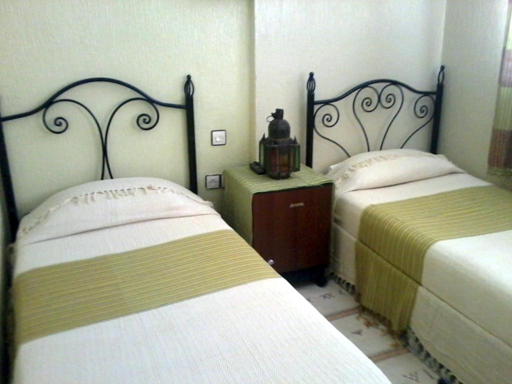 Postel nebo postele na pokoji v ubytování Hôtel Tijani