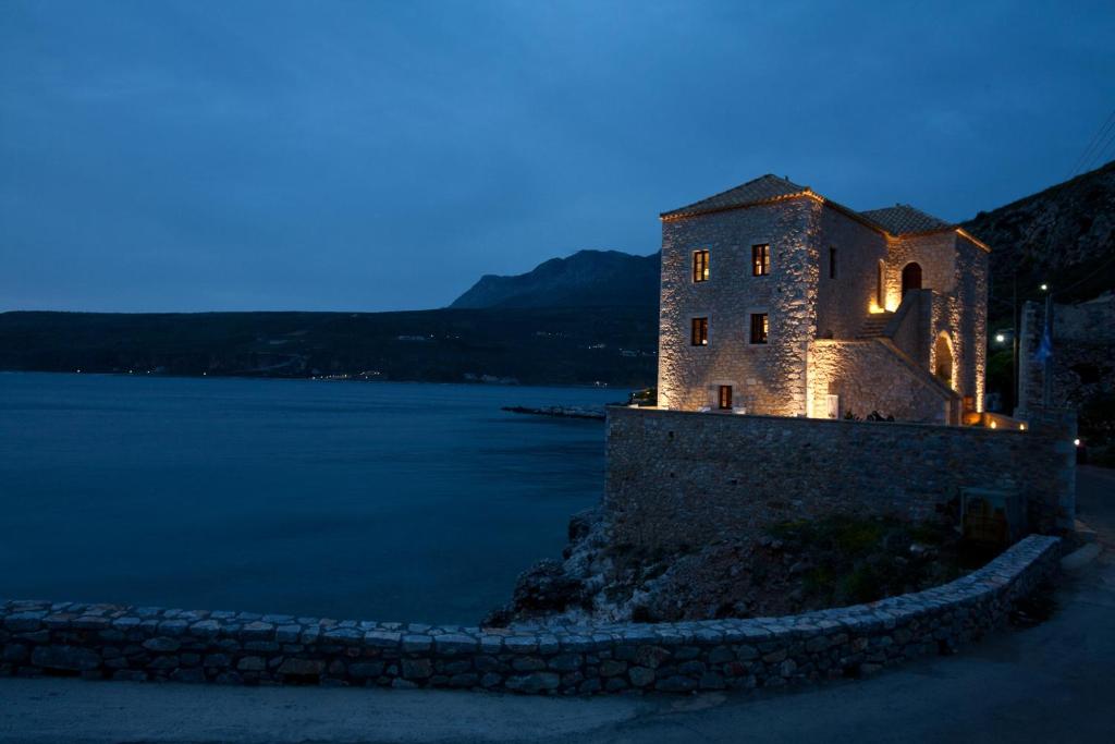 an old building on the side of a body of water at Mavromichalai in Limeni