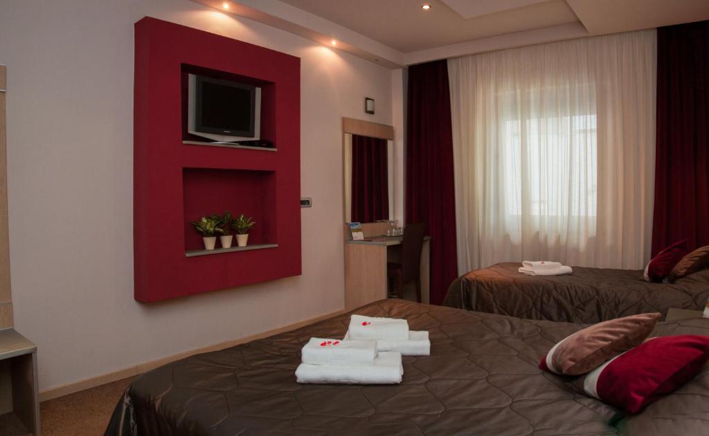 Postel nebo postele na pokoji v ubytování Garni Hotel Vigor - EV station