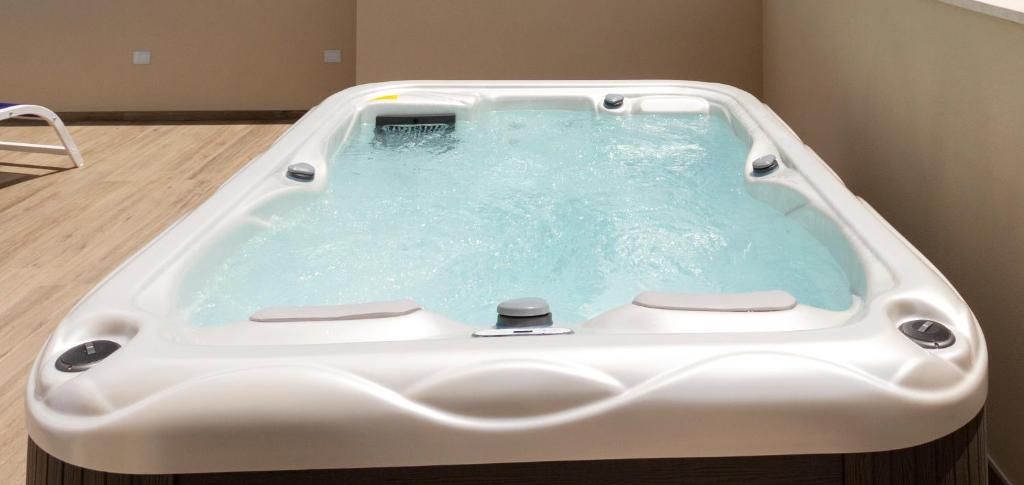 a large bath tub with a white bath tub at Hotel Nautilus in Cagliari