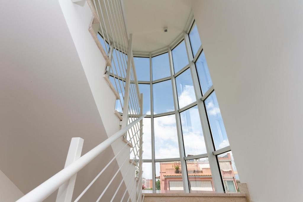 a spiral staircase in a building with a glass ceiling at Hotel Nautilus in Cagliari