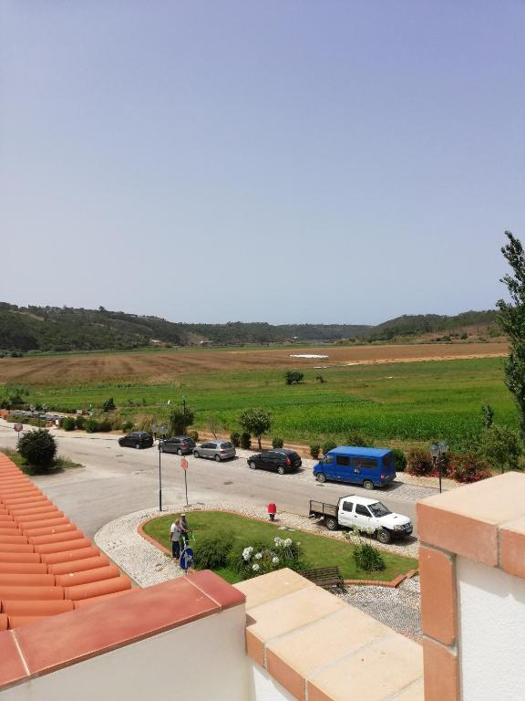a person riding a bike in a parking lot at Sol Mar in Odeceixe